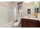 Cozy bathroom featuring a shower-tub combo and a dark wood vanity with a light countertop at 19889 W Sherman St, Buckeye, AZ 85326
