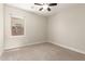 Comfortable bedroom with plush carpet, ceiling fan, and window view at 19889 W Sherman St, Buckeye, AZ 85326