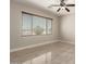 Bedroom featuring tile flooring, neutral paint, ceiling fan, and a large window with blinds at 19889 W Sherman St, Buckeye, AZ 85326