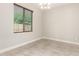 Comfortable bedroom with tile flooring, ceiling fan, and window view at 19889 W Sherman St, Buckeye, AZ 85326