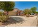 Beautiful single-story home with a well-maintained yard, two-car garage, and inviting curb appeal at 19889 W Sherman St, Buckeye, AZ 85326