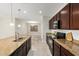 Open-concept kitchen with a large island, modern appliances, and views into the dining and living areas at 19889 W Sherman St, Buckeye, AZ 85326