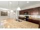 Large kitchen island with a double sink, granite countertops, and pendant lighting at 19889 W Sherman St, Buckeye, AZ 85326