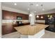 Spacious kitchen featuring a large island, dark wood cabinets, and modern stainless steel appliances at 19889 W Sherman St, Buckeye, AZ 85326