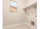 Convenient laundry room with stylish tile flooring and natural light at 19889 W Sherman St, Buckeye, AZ 85326