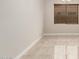 Living room corner featuring tile flooring, neutral paint, blinds on the window, and a chandelier at 19889 W Sherman St, Buckeye, AZ 85326