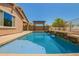 Beautiful pool featuring a waterfall feature and serene landscaping, creating a tranquil backyard oasis at 19889 W Sherman St, Buckeye, AZ 85326