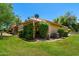 Well-maintained backyard features a lawn, garden, and a house exterior with lush landscaping at 212 Leisure World --, Mesa, AZ 85206