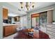 Cozy dining area with a chandelier, direct access to the patio, and views of the kitchen at 212 Leisure World --, Mesa, AZ 85206