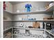 A well-organized walk-in pantry showcases shelving with decorative displays and functional storage solutions for kitchen essentials at 212 Leisure World --, Mesa, AZ 85206