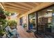Inviting covered patio with tile flooring, seating, and glass doors to the interior at 212 Leisure World --, Mesa, AZ 85206