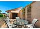 Charming patio area with outdoor seating, a glass table, and climbing vines, perfect for relaxation and entertaining at 212 Leisure World --, Mesa, AZ 85206