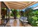 Inviting patio area features comfortable seating with a bench, a small table, tiled flooring, and a shaded area, promoting relaxation at 212 Leisure World --, Mesa, AZ 85206