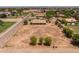 Aerial view of a property with an expansive lot, house, and nearby community amenities at 22201 E Vallejo St, Queen Creek, AZ 85142