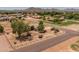 Expansive property featuring a single-story home, mature trees, and picturesque mountain views at 22201 E Vallejo St, Queen Creek, AZ 85142