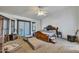 Primary bedroom with large bed, sitting area, and natural light from the window at 22201 E Vallejo St, Queen Creek, AZ 85142