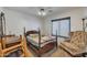 Cozy bedroom with a four-poster bed, chair, and natural light at 22201 E Vallejo St, Queen Creek, AZ 85142