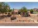 Charming home with mature trees, desert landscaping, and a welcoming walkway leading to the entrance at 22201 E Vallejo St, Queen Creek, AZ 85142