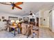 Cozy living room with multiple ceiling fans, fireplace, and tile flooring with a view to another room at 22201 E Vallejo St, Queen Creek, AZ 85142