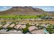Aerial view of the community with homes, green spaces, and mountain backdrop at 27713 N 57Th Dr, Phoenix, AZ 85083