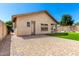 Spacious backyard showcasing a covered patio, artificial lawn, and inviting hardscape, ideal for entertaining at 27713 N 57Th Dr, Phoenix, AZ 85083