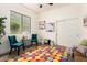 Playful bedroom with bright rug, whimsical decor, and comfortable seating at 27713 N 57Th Dr, Phoenix, AZ 85083