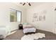 Bright bedroom with large window, white armchair, and decorative wall art, creating a tranquil living space at 27713 N 57Th Dr, Phoenix, AZ 85083