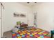 Playful bedroom with bright rug, whimsical decor, and comfortable seating at 27713 N 57Th Dr, Phoenix, AZ 85083