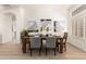 Formal dining room with table setting, wood-look floors, and natural light at 27713 N 57Th Dr, Phoenix, AZ 85083
