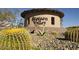 Community entrance with decorative landscaping and desert vegetation at 27713 N 57Th Dr, Phoenix, AZ 85083
