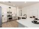 Contemporary kitchen with stainless steel appliances, white cabinetry, tile backsplash and island at 27713 N 57Th Dr, Phoenix, AZ 85083