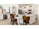 Open kitchen features a large island with seating, white cabinets, stainless steel appliances, and lots of counter space at 27713 N 57Th Dr, Phoenix, AZ 85083