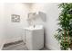Efficient laundry room with modern white appliances, stylish shelf decor, and practical flooring at 27713 N 57Th Dr, Phoenix, AZ 85083