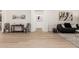 Open floor plan showcases light wood floors, chic decor, and seamless flow into other areas of the home at 27713 N 57Th Dr, Phoenix, AZ 85083