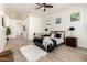 Bright primary bedroom has light wood floors, ceiling fan, and lots of windows letting in natural light at 27713 N 57Th Dr, Phoenix, AZ 85083