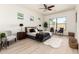 Spacious primary bedroom features a ceiling fan, plush bedding, and large windows for ample natural light at 27713 N 57Th Dr, Phoenix, AZ 85083