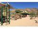 Fun community playground featuring climbing structures and slides in a sandy play area at 27713 N 57Th Dr, Phoenix, AZ 85083