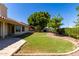 Image showcasing the beautifully landscaped backyard and the exterior of the property at 319 N Riata St, Gilbert, AZ 85234