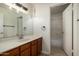 Bathroom featuring wood cabinets and an extended white countertop at 319 N Riata St, Gilbert, AZ 85234