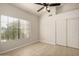 Bedroom showcases light wood flooring, closet, a ceiling fan, and window at 319 N Riata St, Gilbert, AZ 85234