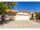 Two car garage with desert-style landscaping and a terracotta roof, showcasing curb appeal at 319 N Riata St, Gilbert, AZ 85234