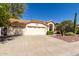 Home featuring a spacious two-car garage, a tile roof, and low-maintenance desert landscaping at 319 N Riata St, Gilbert, AZ 85234