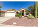 Attractive front exterior showcasing a terracotta tiled roof and low-maintenance desert landscaping at 319 N Riata St, Gilbert, AZ 85234