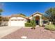 Charming single-story home featuring a tile roof, desert landscaping, and a two-car garage at 319 N Riata St, Gilbert, AZ 85234