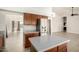 Modern kitchen with stainless steel refrigerator and island, showcasing the open layout to living space at 319 N Riata St, Gilbert, AZ 85234