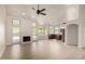Light, open-concept living area with hardwood flooring, a fireplace and access to kitchen at 319 N Riata St, Gilbert, AZ 85234
