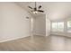 Bright and airy living room with a ceiling fan and ample natural light from the windows at 319 N Riata St, Gilbert, AZ 85234