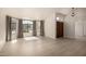 Bright living room with hardwood floors, large windows with drapes, and a front door view at 319 N Riata St, Gilbert, AZ 85234