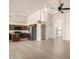 Bright open living space with modern flooring flowing into a kitchen with stainless steel appliances and center island at 319 N Riata St, Gilbert, AZ 85234