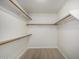 Bright walk-in closet features wooden shelving and light wood flooring at 319 N Riata St, Gilbert, AZ 85234